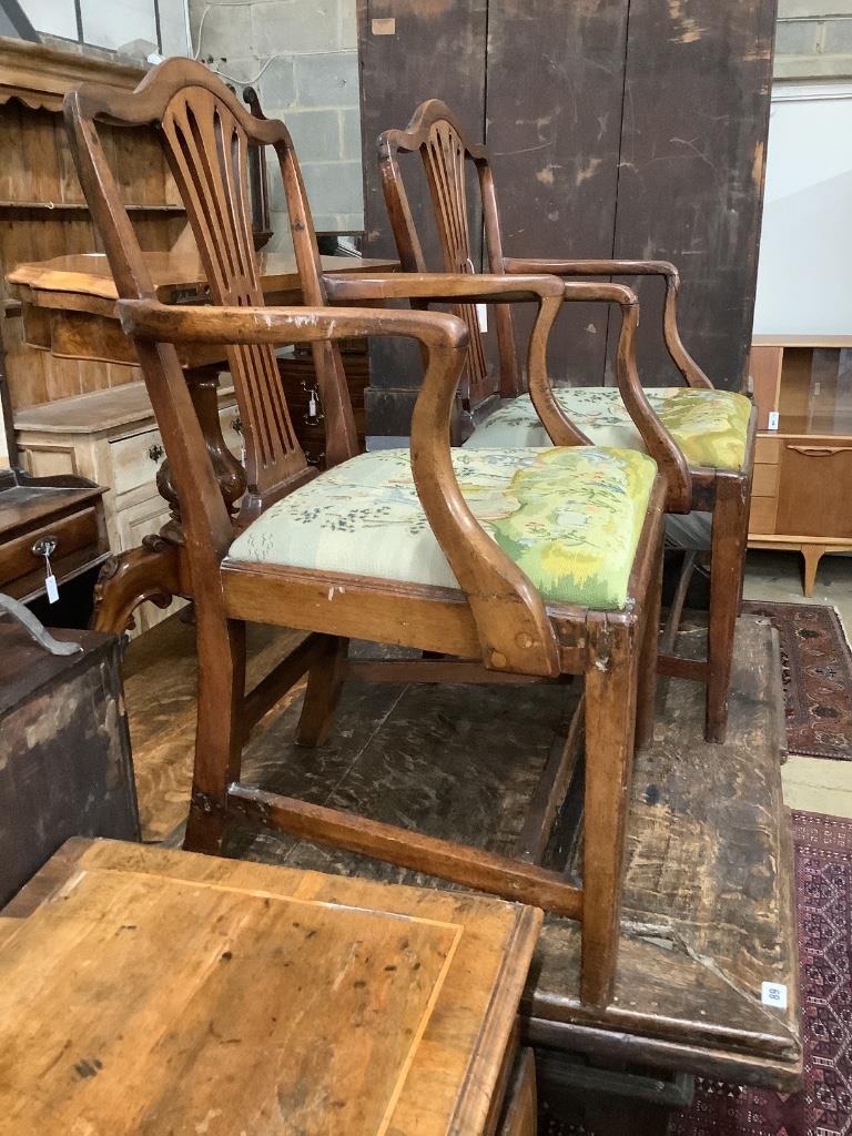 A pair of George III mahogany open elbow chairs